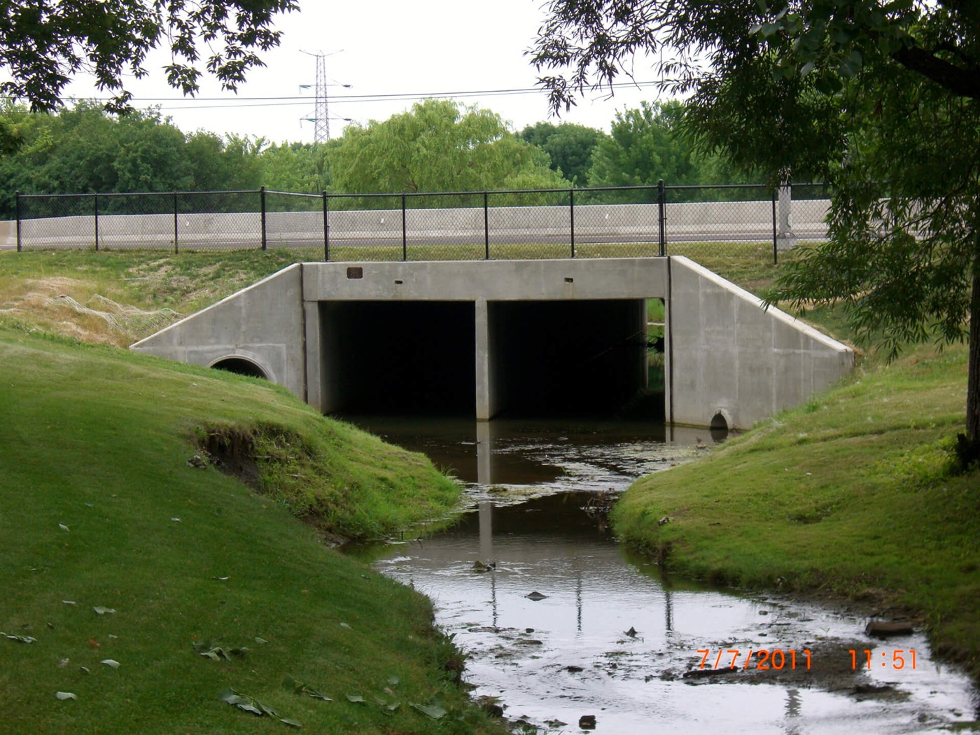 Multi-barrel reinforced concrete box culvert with headwall and channel — typical structure inspected by CIA