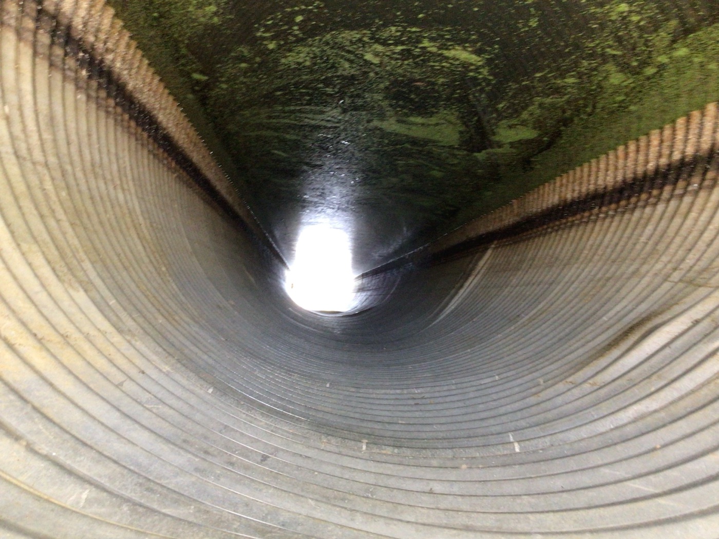 Roadway pavement showing multiple deflection points above a buried structure